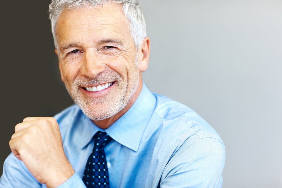 man smiling with new dental implants