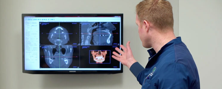 oral surgeon looking at x-rays